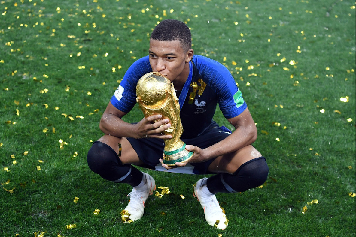 Soccer_World Cup_ forward Kylian Mbappe with the World Cup trophy